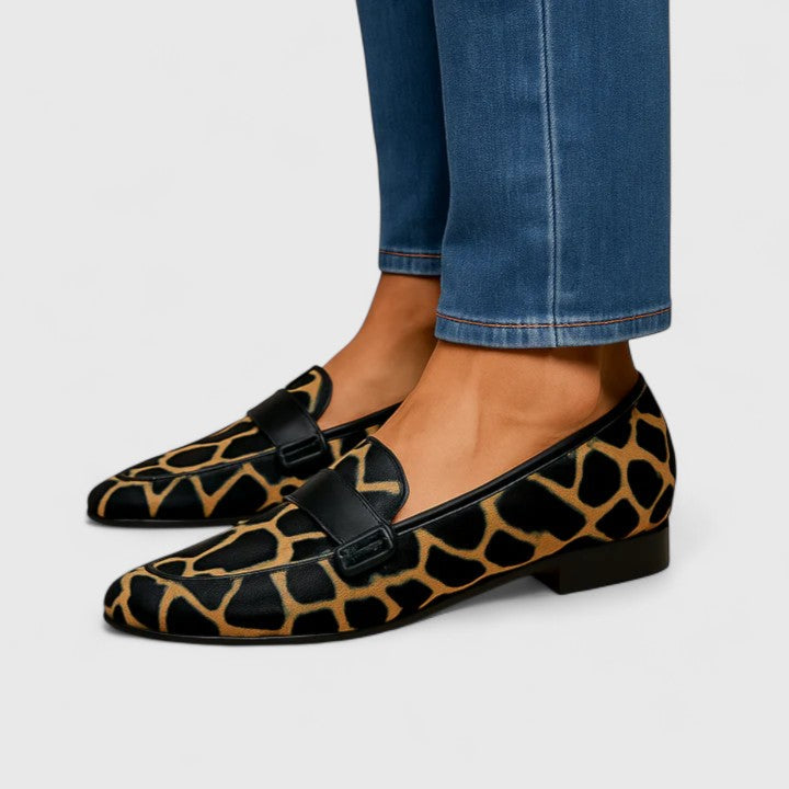 Black loafers with gold detail for women